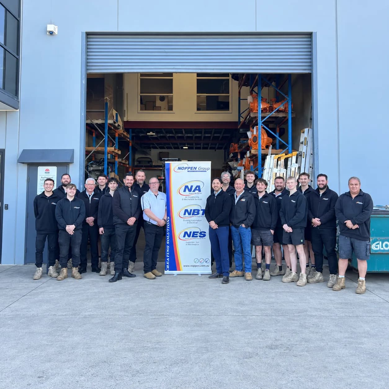 The Noppen Group team standing together in front of the Noppen warehouse